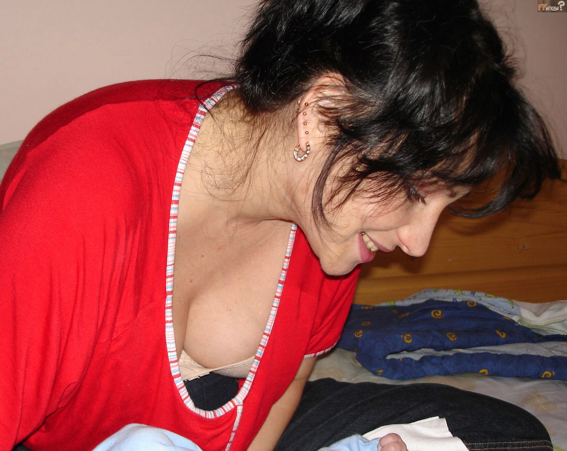 Woman bending over with blouse open showing cleavage